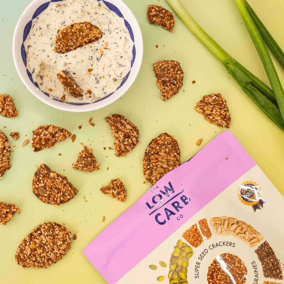 Super Seed Cracker Snacks by The Low Carb Co in a bowl, showcasing their crunchy texture and mixed seed ingredients.