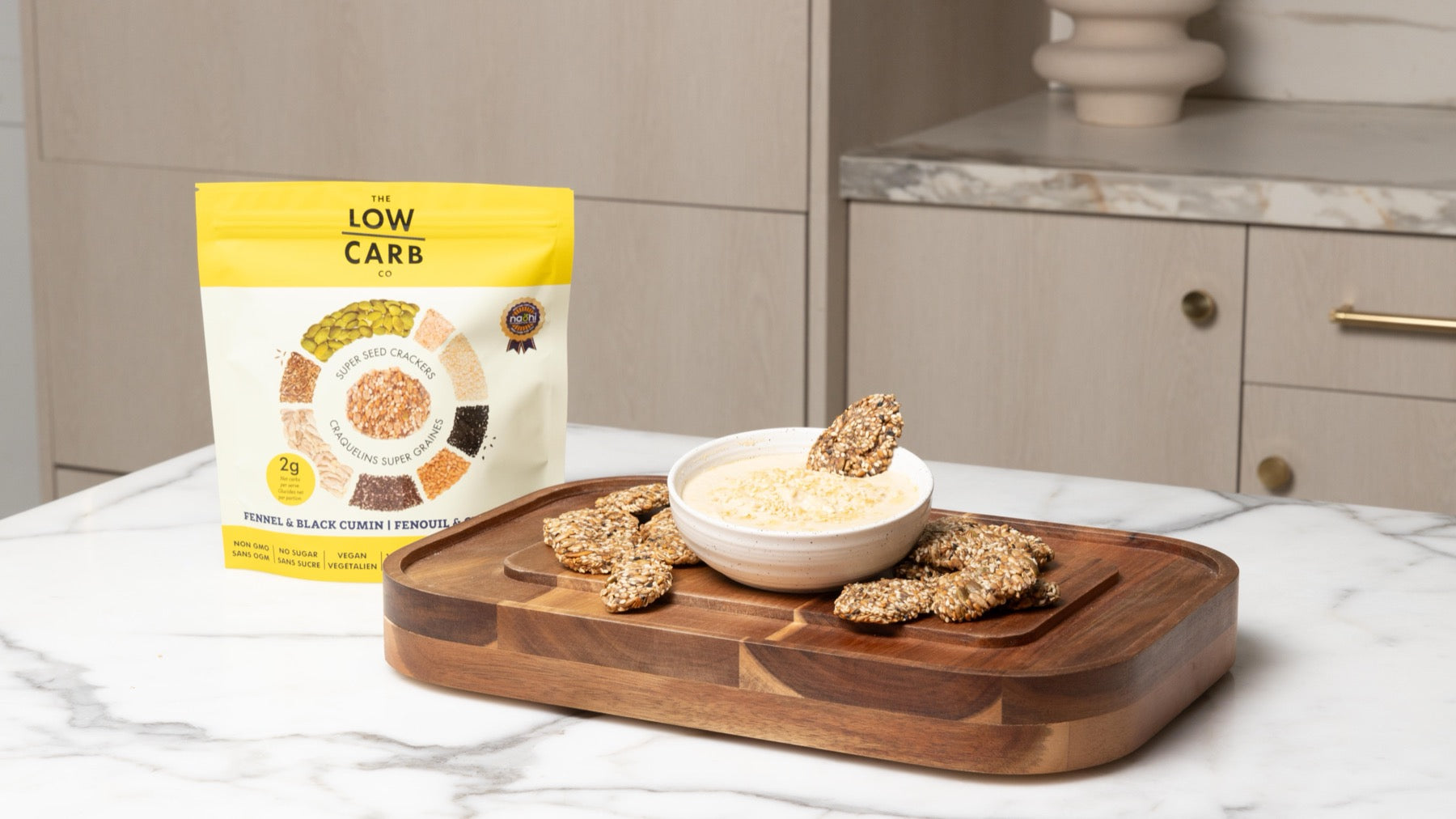 Original-style seed crackers on a serving board with dip
