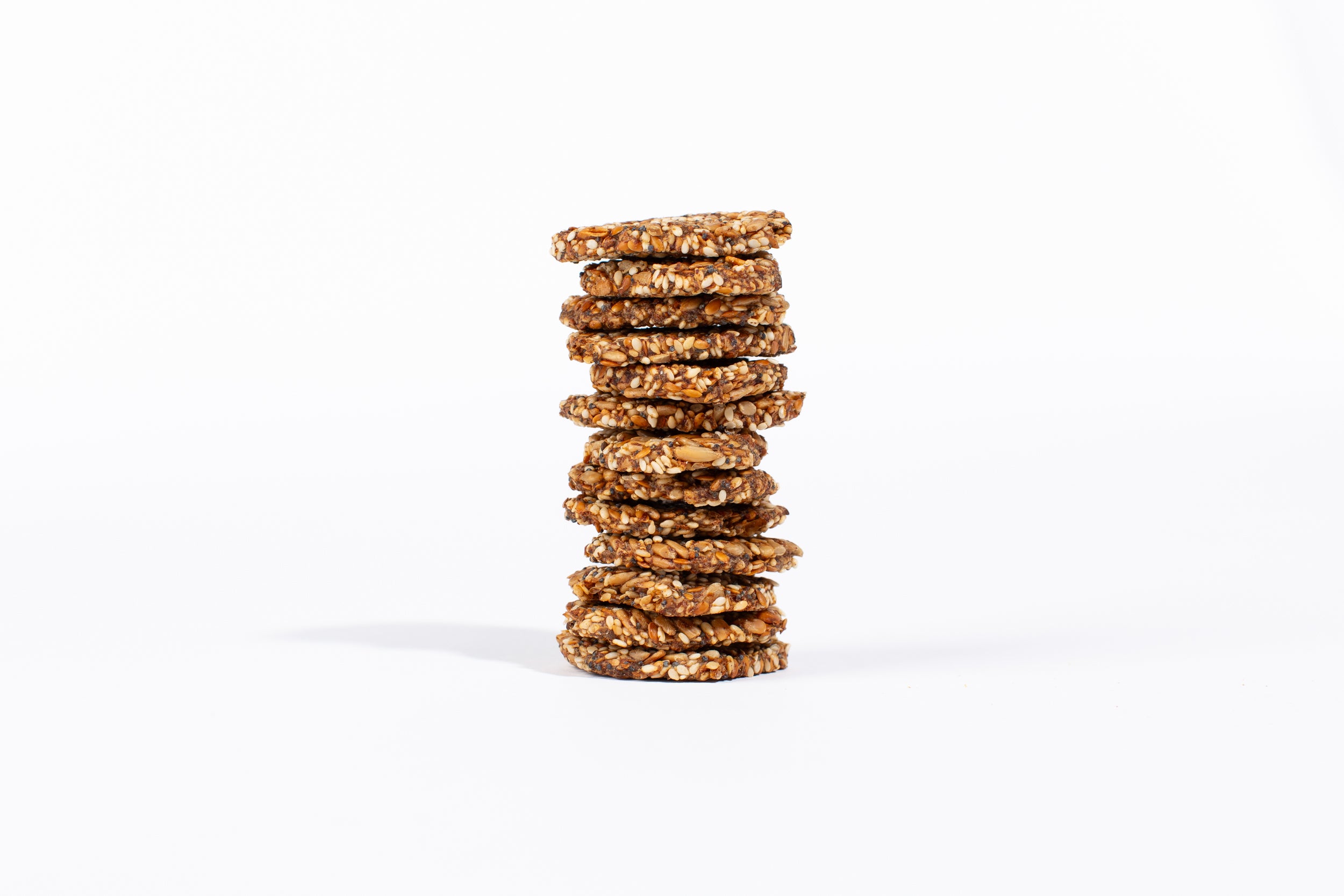A tall stack of seed crackers showing the crunchy texture